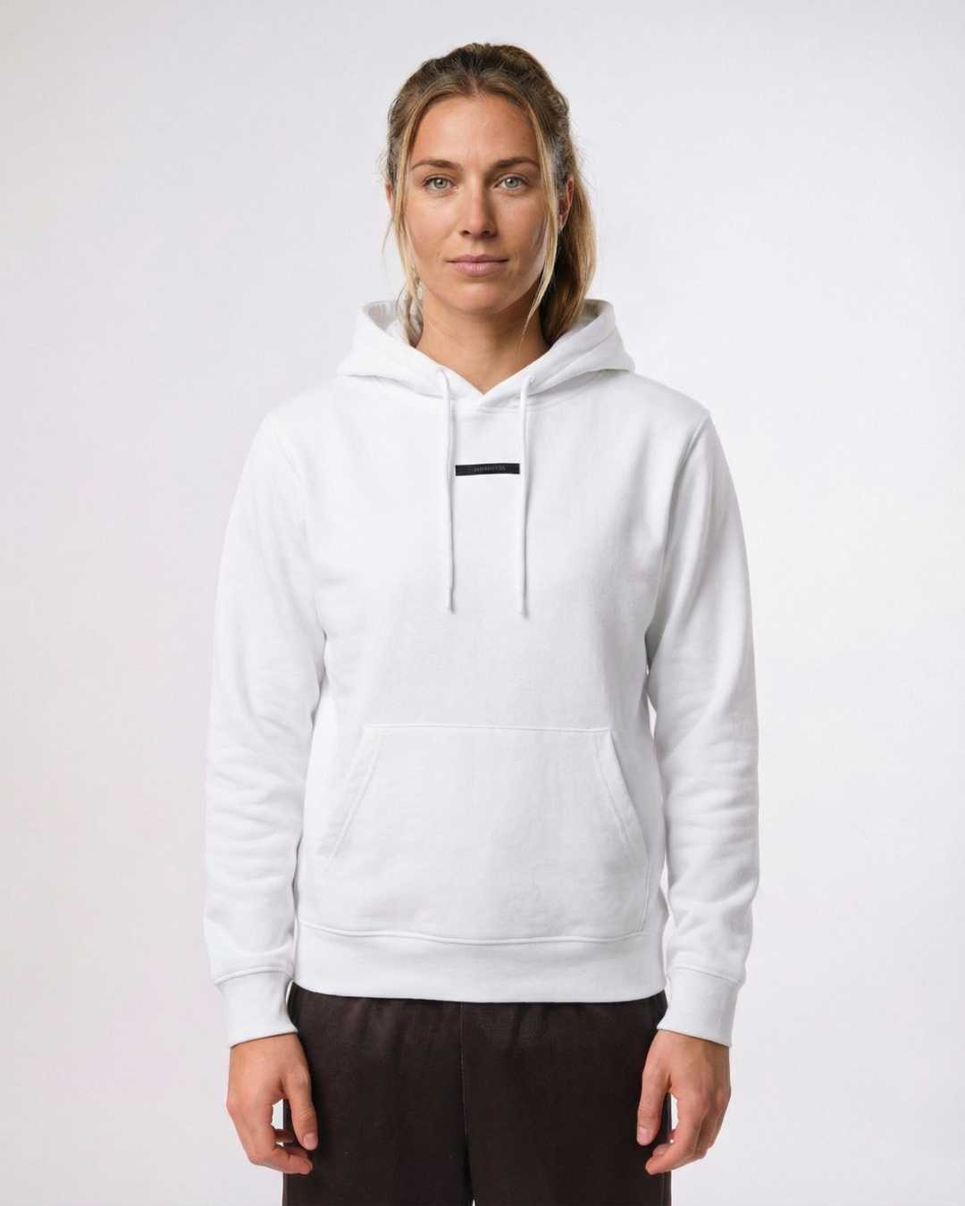 beach volleyball player wearing a white hoodie on a plain background