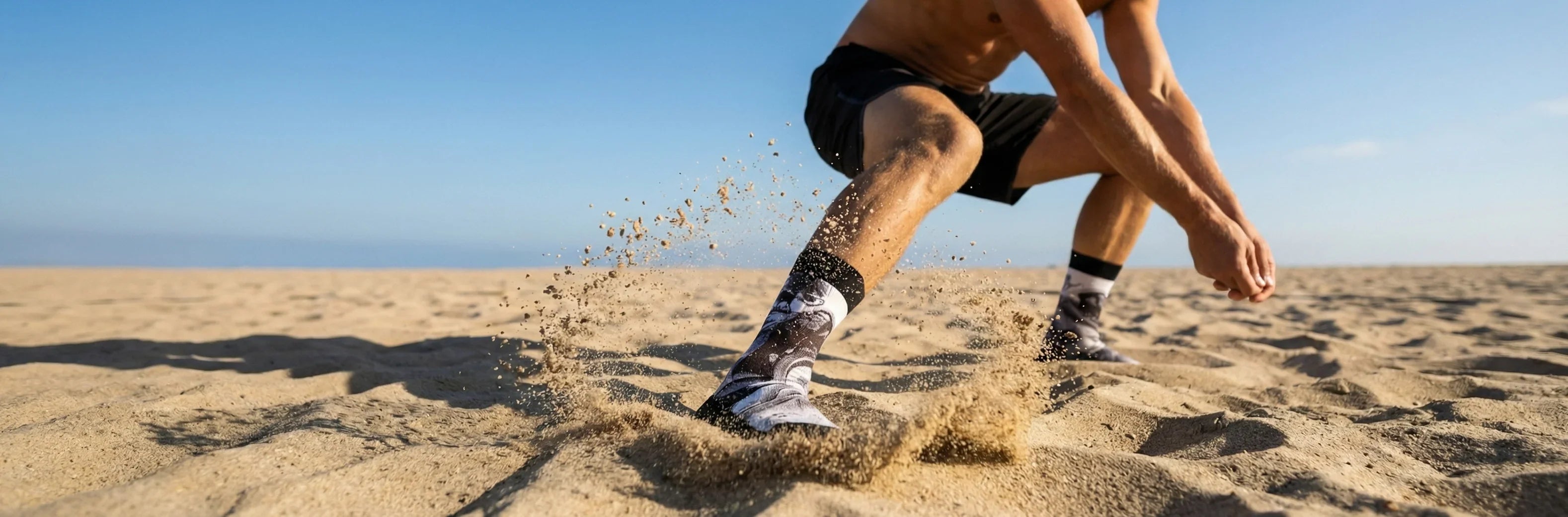 beach volleyball athlete in action wearing STAR Beachwear sand socks on sand court